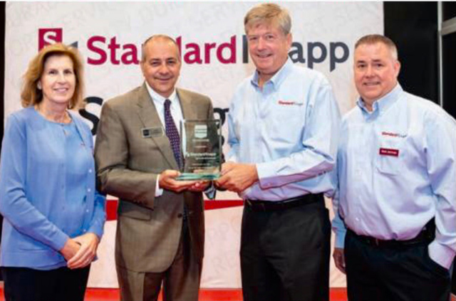 Standard-Knapp receives an award from PMMI for 125 years of excellence. (Left to right) Judy Smith, Standard-Knapp; Jim Pittas, PMMI; Mike Weaver and Mark Jehnings, Standard-Knapp.